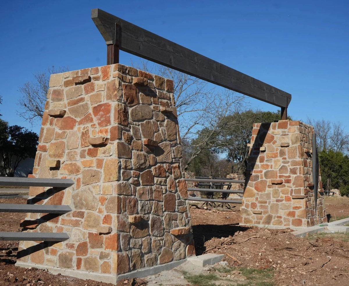 Stone entrance columns and feature wall built by H3 Masonry and Construction