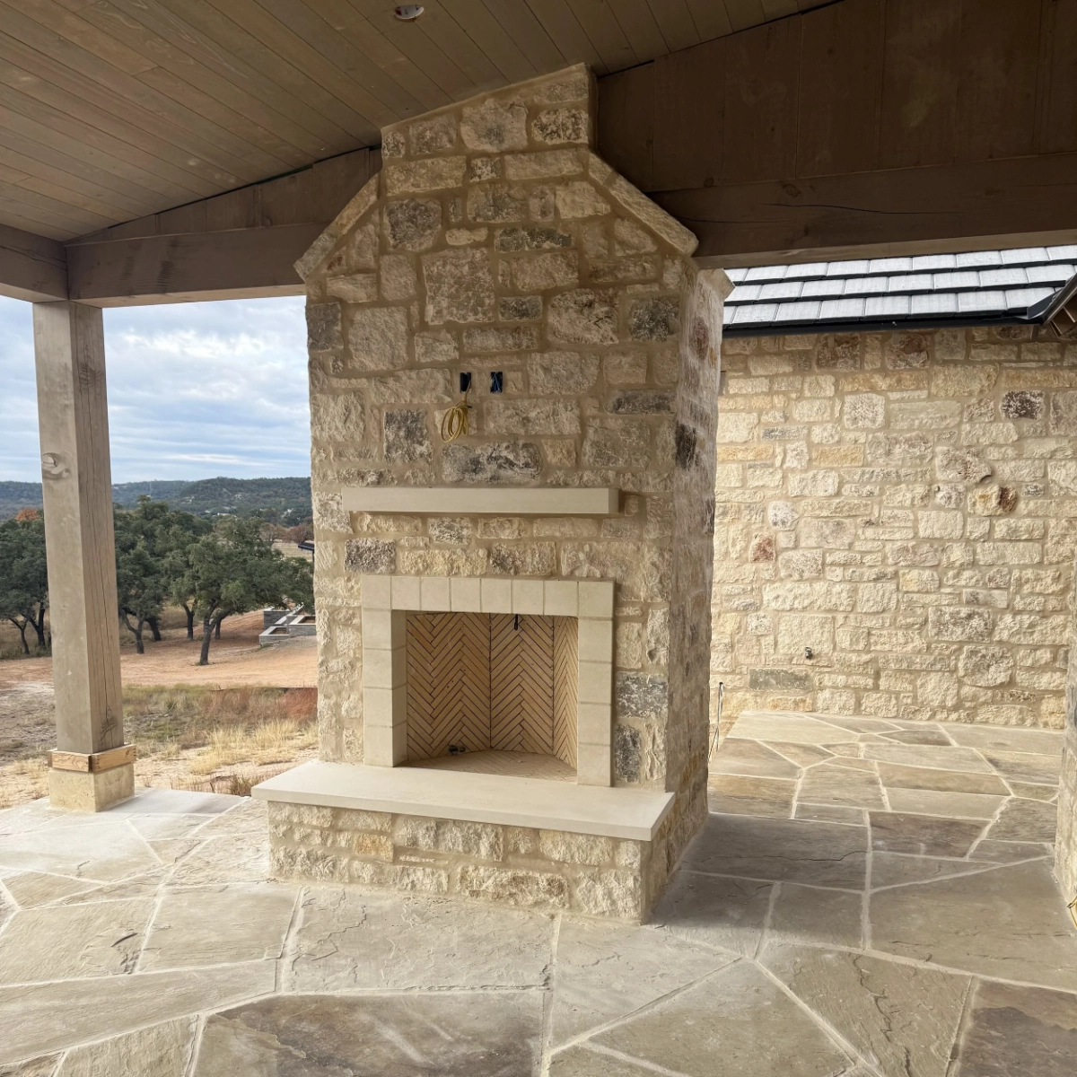 Custom stone fireplace built by H3 Masonry and Construction