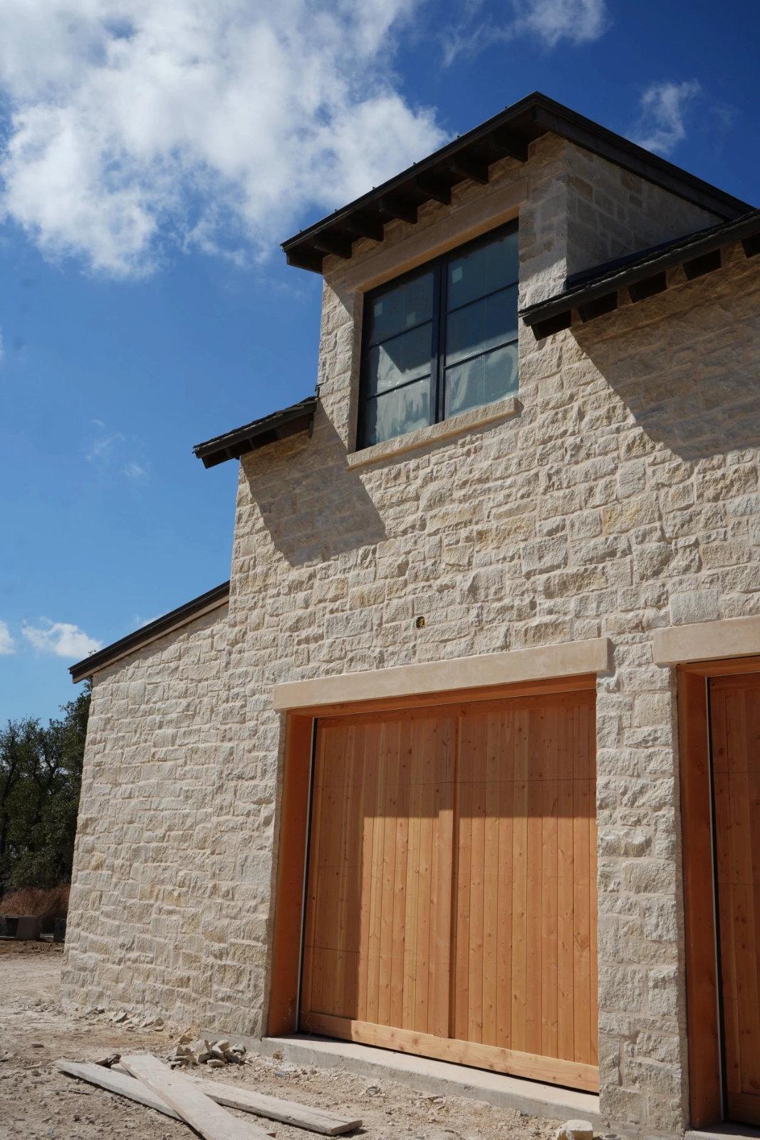 Stone garage facade built by H3 Masonry and Construction